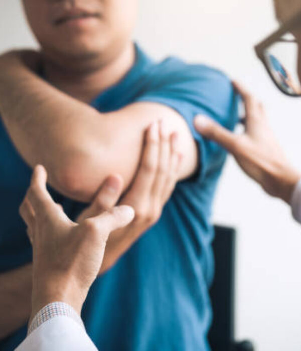 Physical therapists are checking patients elbows at the clinic office room.